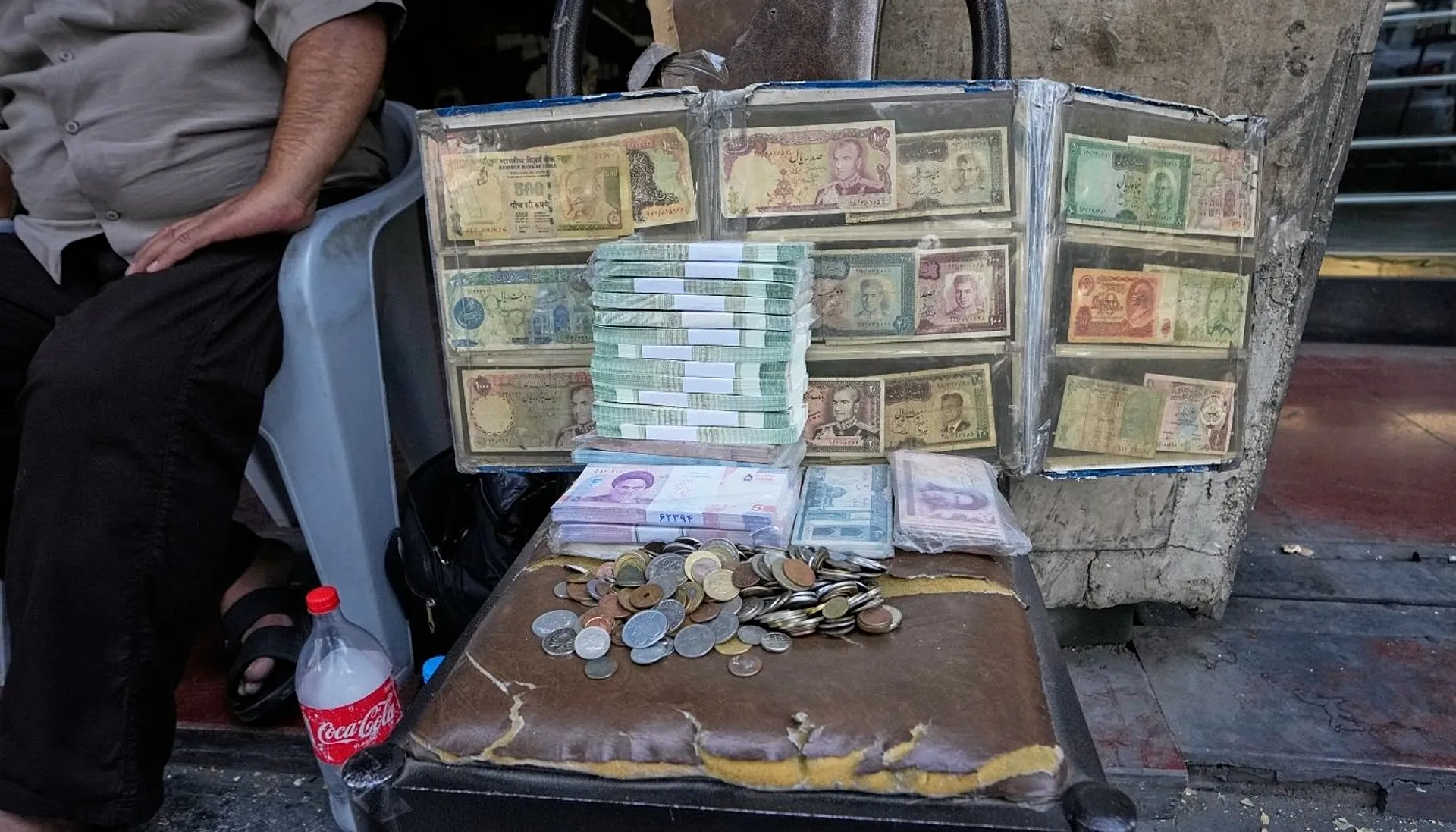 Current and pre-revolution Iranian banknotes are displayed by a street money exchanger at Ferdowsi square, a hub for foreign currency trading in downtown Tehran, Iran, Monday,